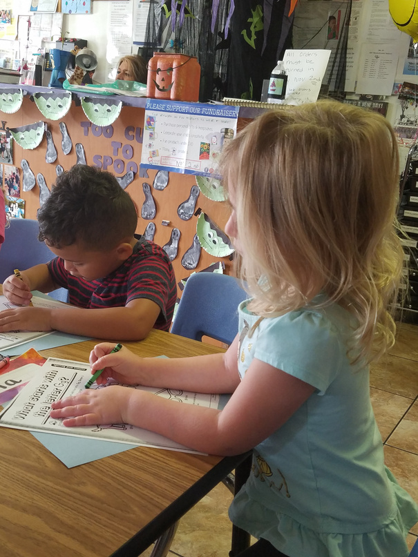 Kids filling out fun activities at Mrs. B's Day Care
